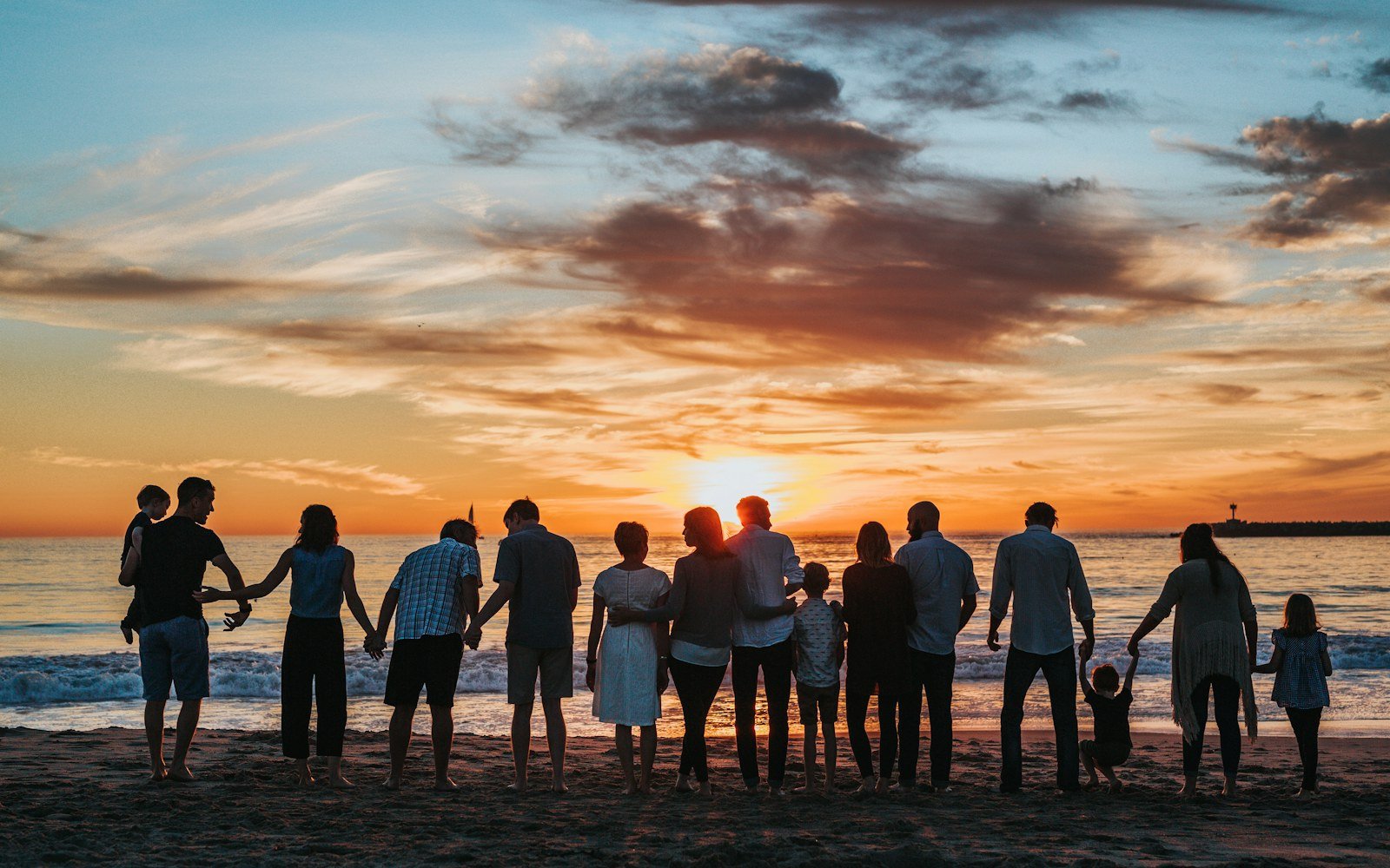 A multigenerational family watching the sunset together