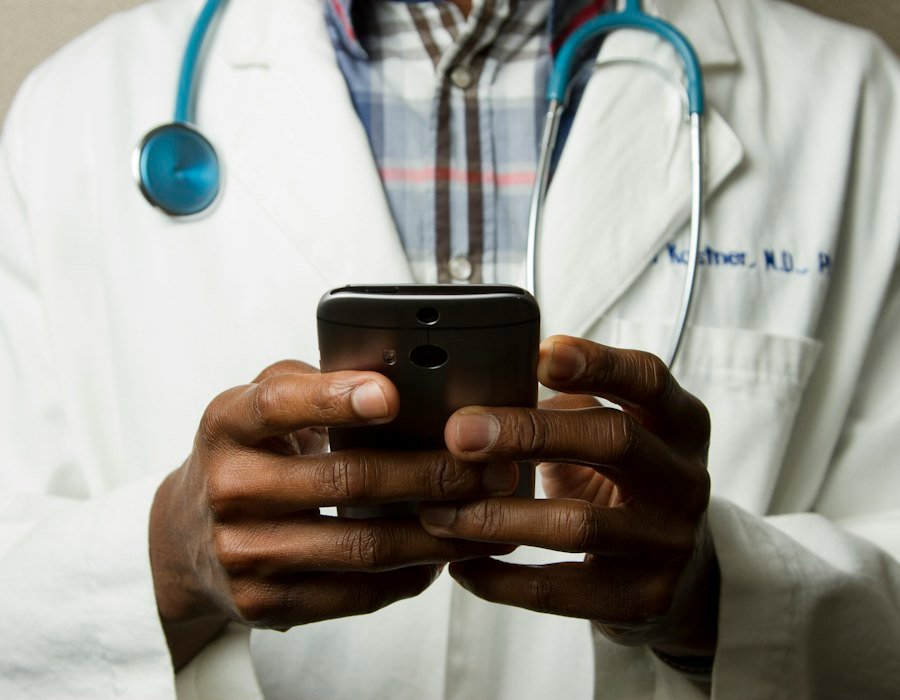 A doctor checking medical information on a phone